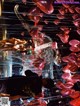 A group of people standing in front of a bunch of balloons.