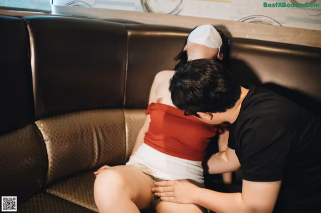 A man and a woman sitting on a couch.