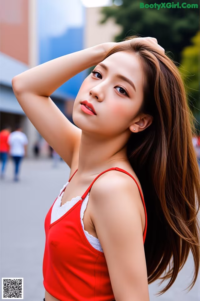 A woman in a red top is posing for a picture.