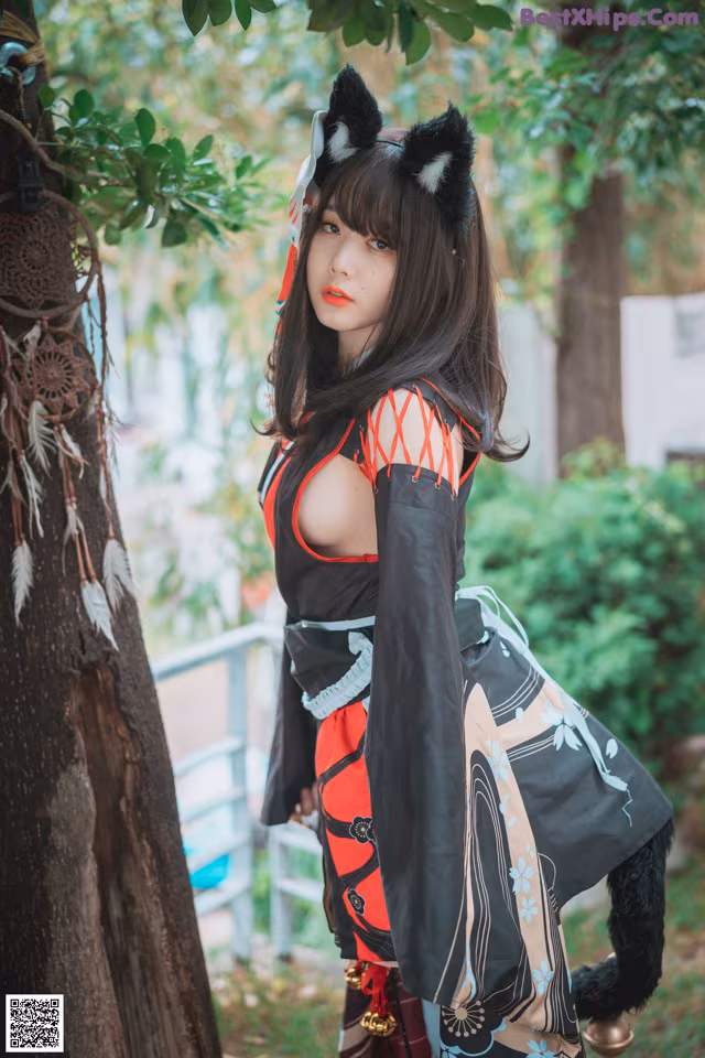A woman in a kimono with a cat ears on her head.